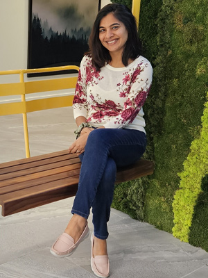 Professional Headshot of a women sitting in a chair in an office